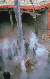 Ritual offering of incense in temple courtyard